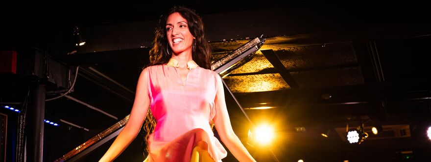Zoe Rahman sat on top of a piano
