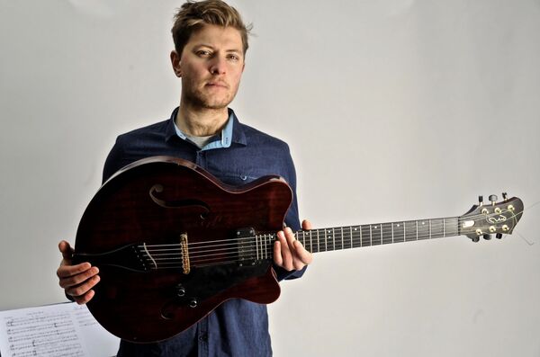 Tom Ollendorff with Guitar