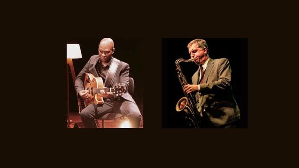 Eddison Herbert playing an acoustic guitar and Simon Spillett on Tenor sax